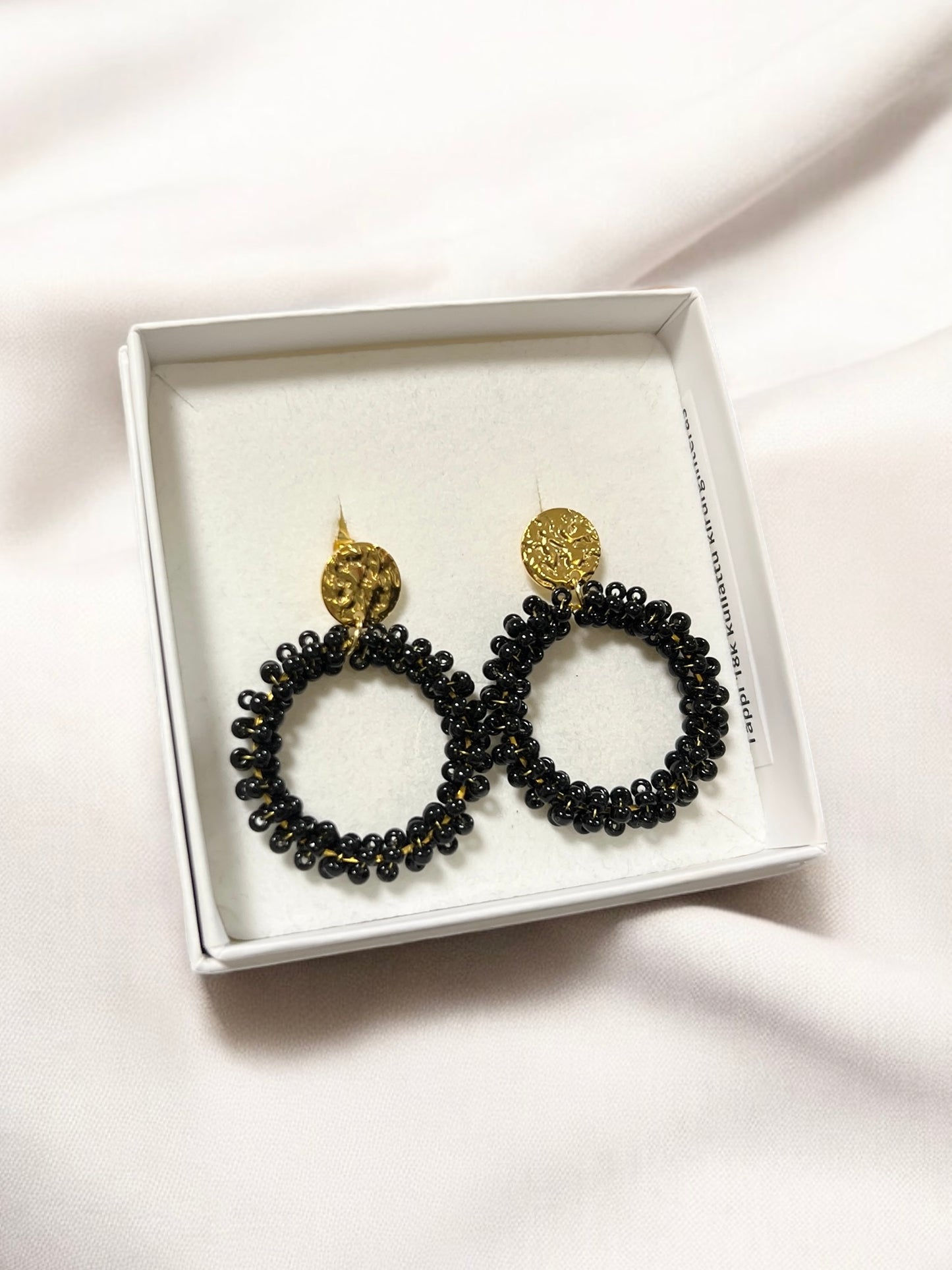 Loviisa earrings, with a jagged button